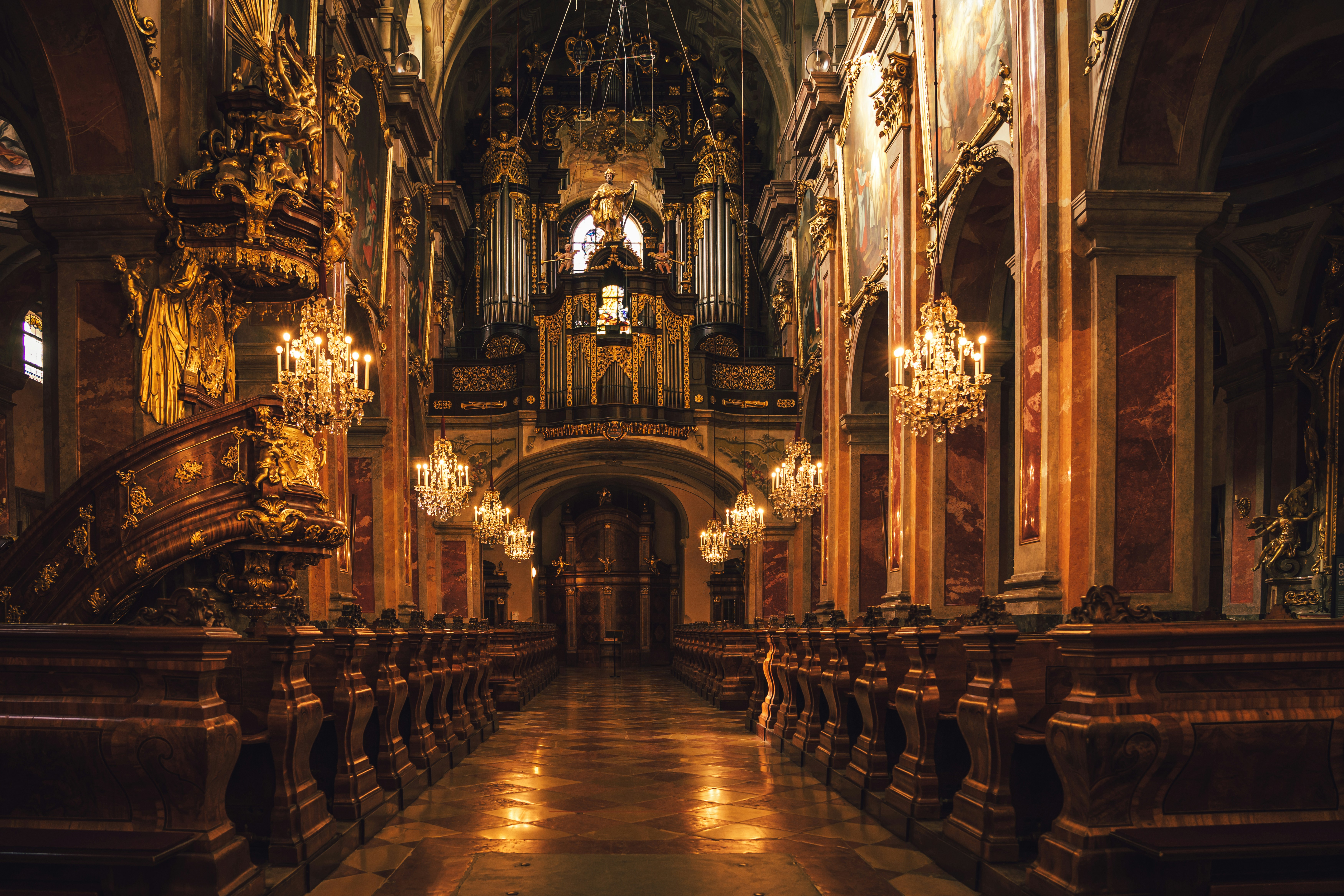 a large cathedral with chandeliers and a clock