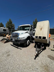 HVAC truck parked outside a home, technician preparing for a service call.