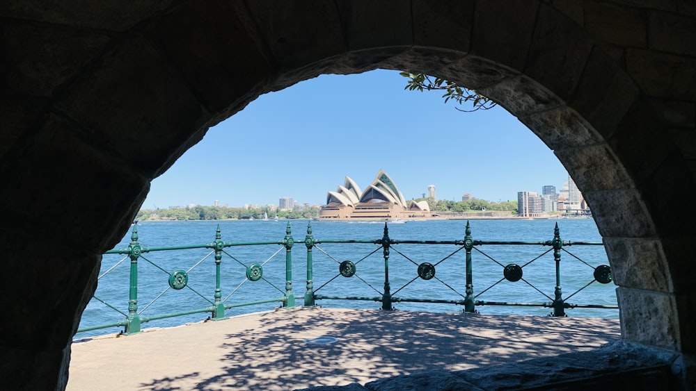 a view of a large body of water through an arch