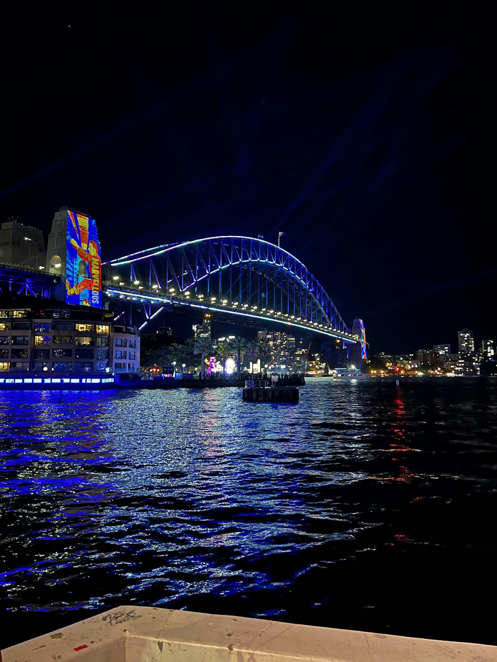 a large bridge over a body of water at night