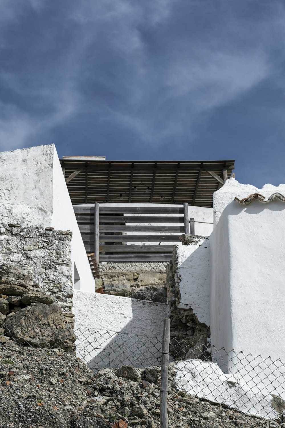 a white building with a wooden bench on top of it