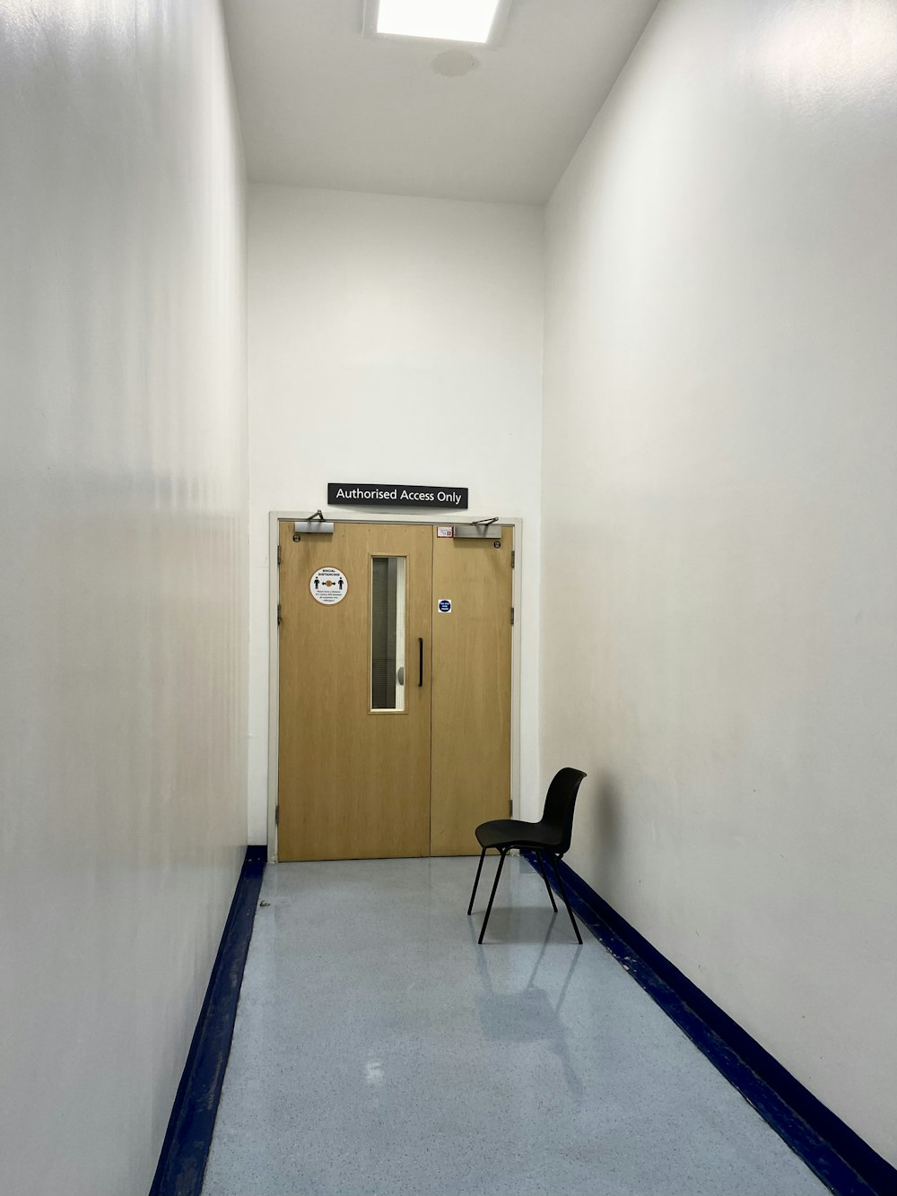 a chair sitting in a hallway next to a door