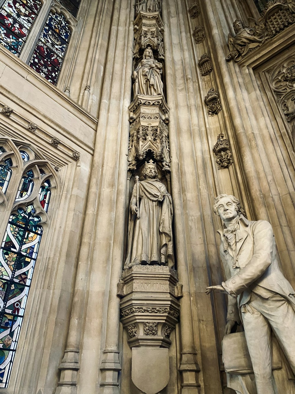 a statue of a man and a woman in front of a cathedral
