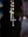 A close-up of a beautifully arranged rosary on a wooden table.