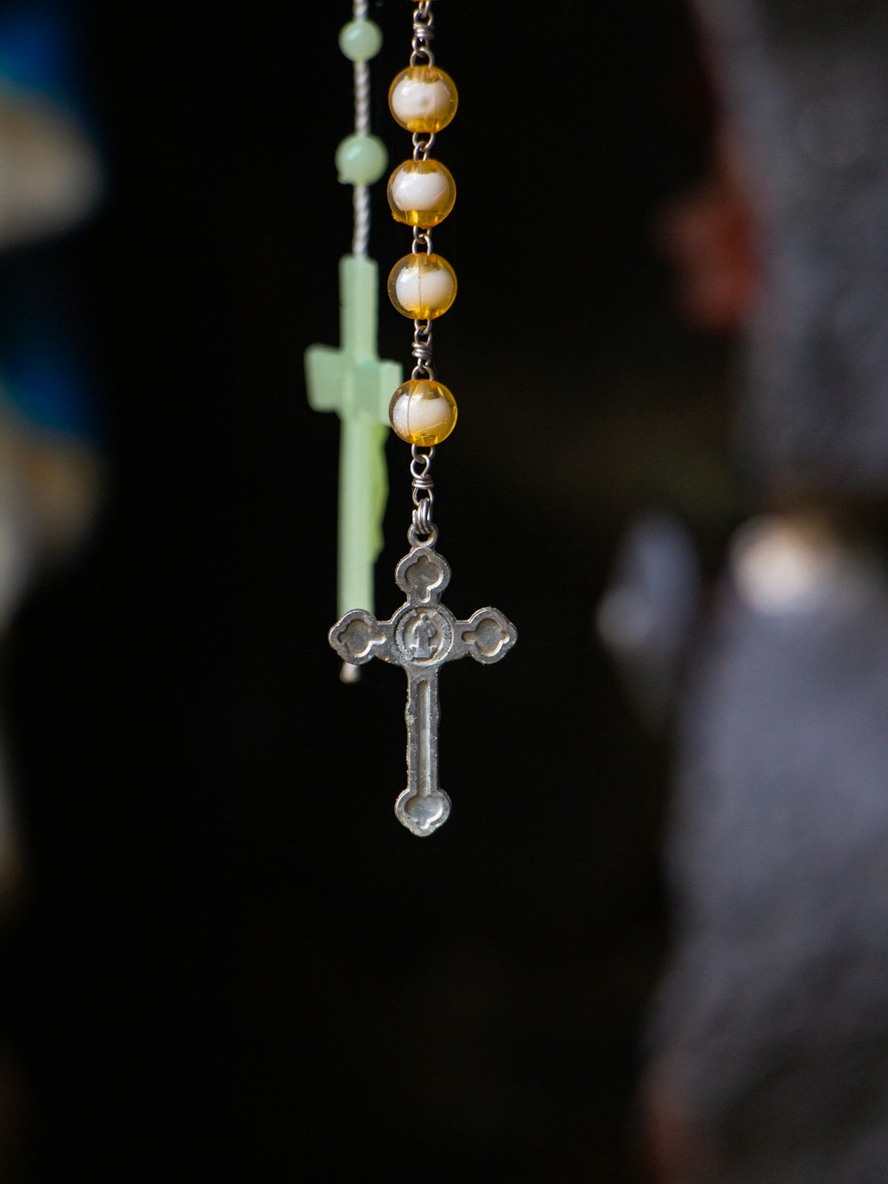 a rosary with a cross hanging from it