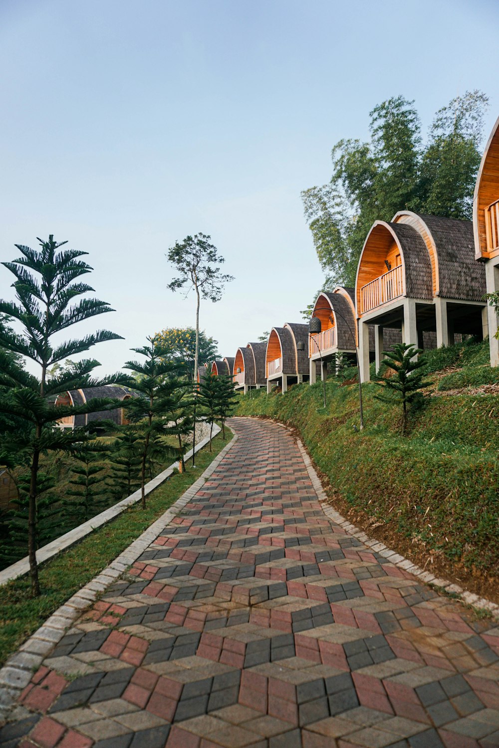 a brick pathway leading to a row of cabins