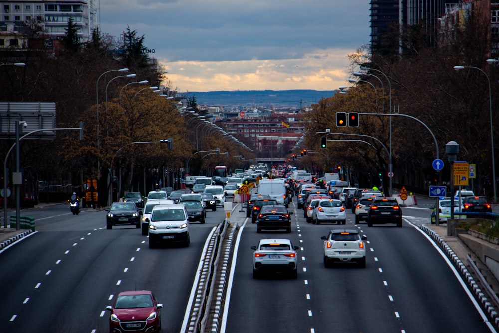 a street filled with lots of traffic next to tall buildings