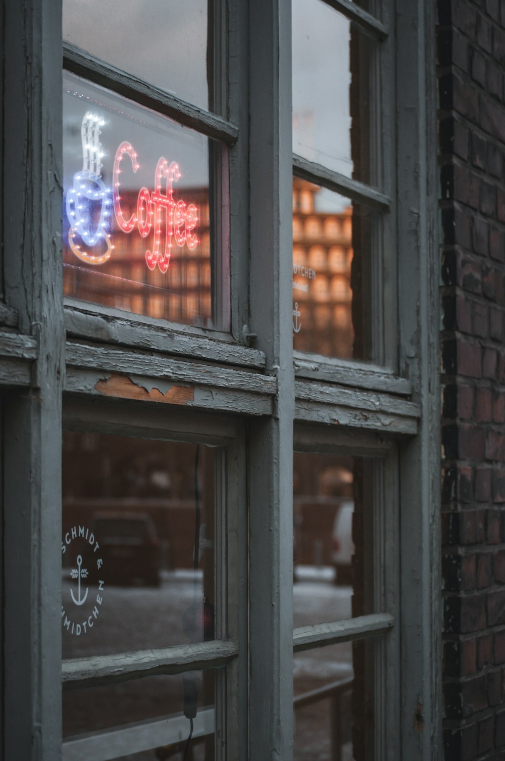 a window with a sign that says coffee on it