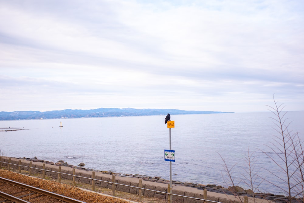 a train track next to a body of water