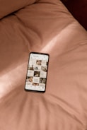 a cell phone sitting on top of a bed