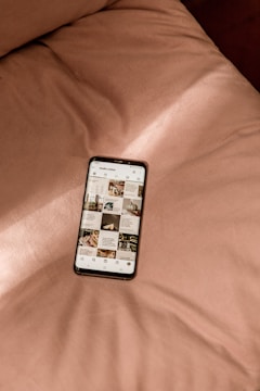 a cell phone sitting on top of a bed