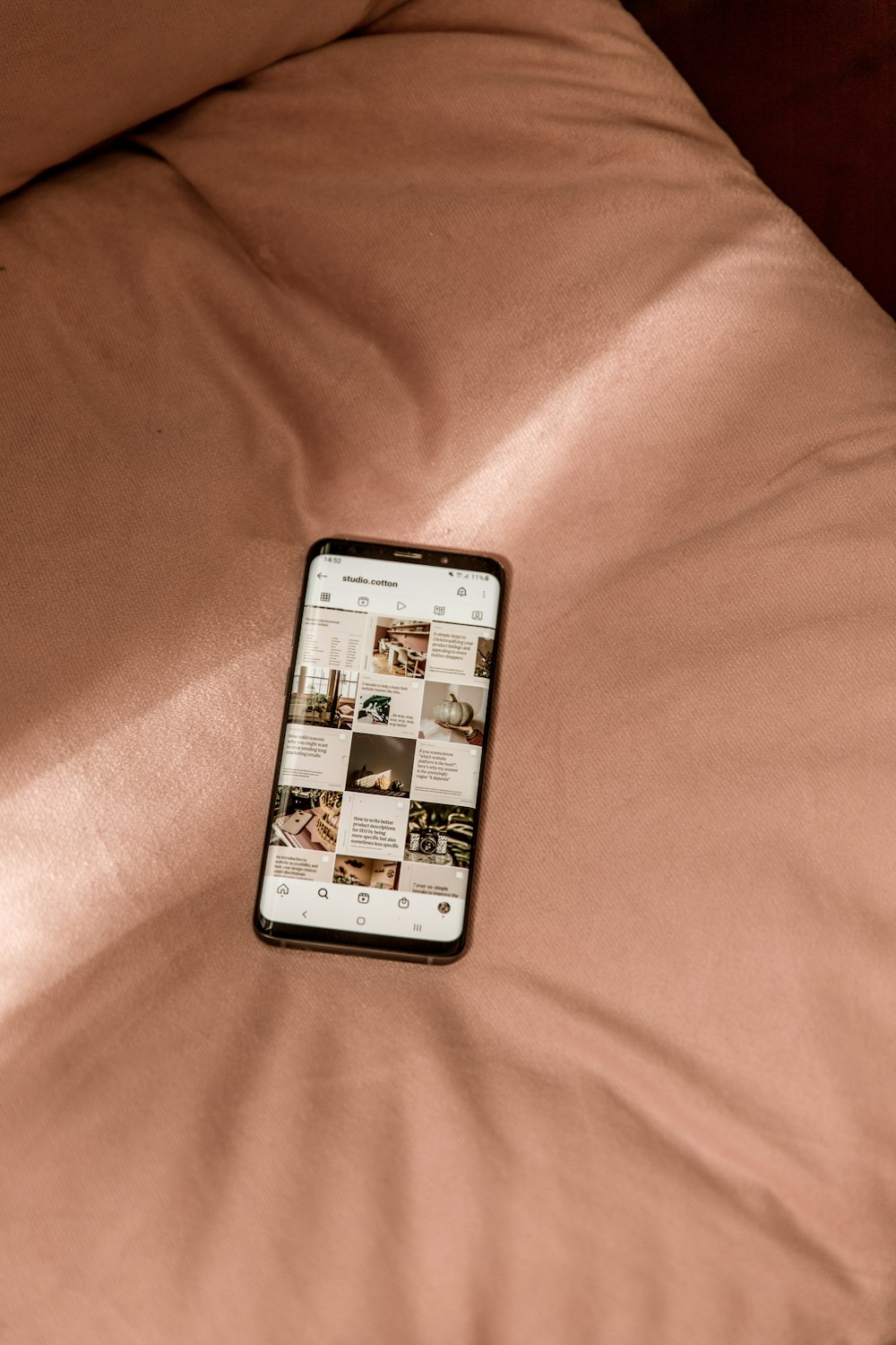 a cell phone sitting on top of a bed