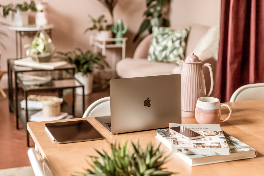 a wooden table topped with a laptop computer