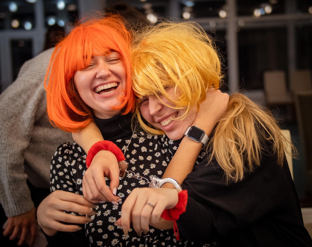 two young women hugging each other at a party
