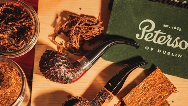 Close-up of assorted tobacco pipes arranged on a wooden surface