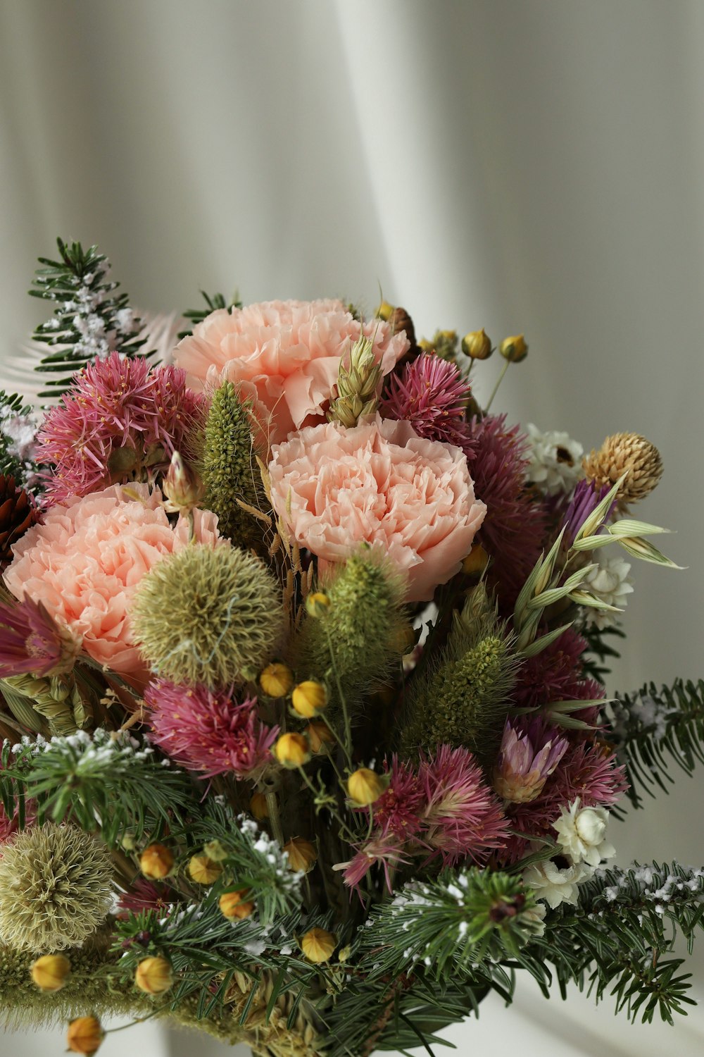 a bouquet of pink flowers sitting on top of a table