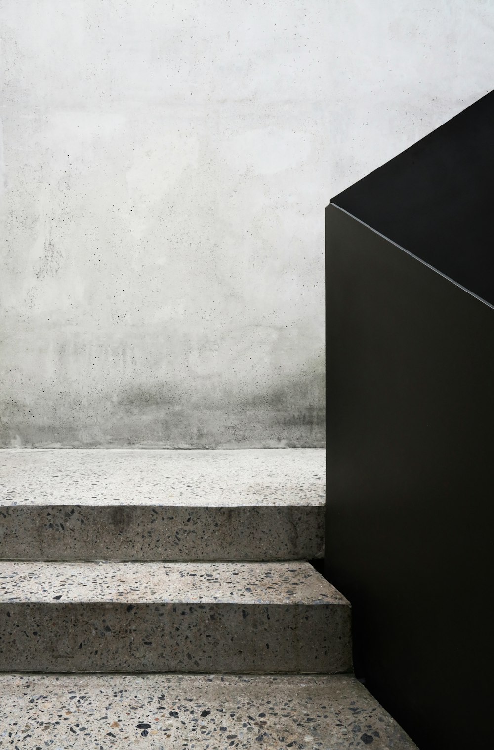 a black box sitting on top of a set of stairs