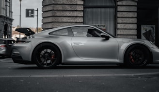 A sleek car parked on a city street ready for rental.