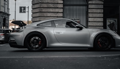 Sleek silver hatchback parked on a Glasgow street with city buildings in the background.