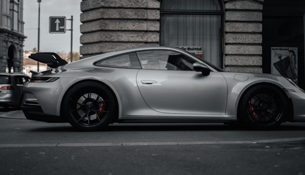 A sleek car parked on a city street ready for rental.