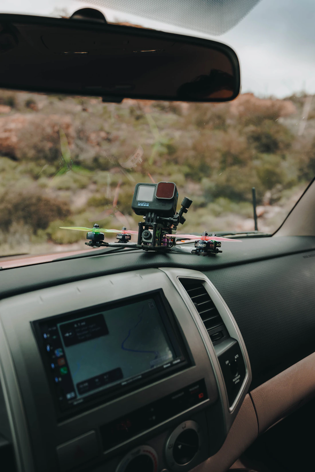 Dash camera mounted inside a vehicle above the dashboard