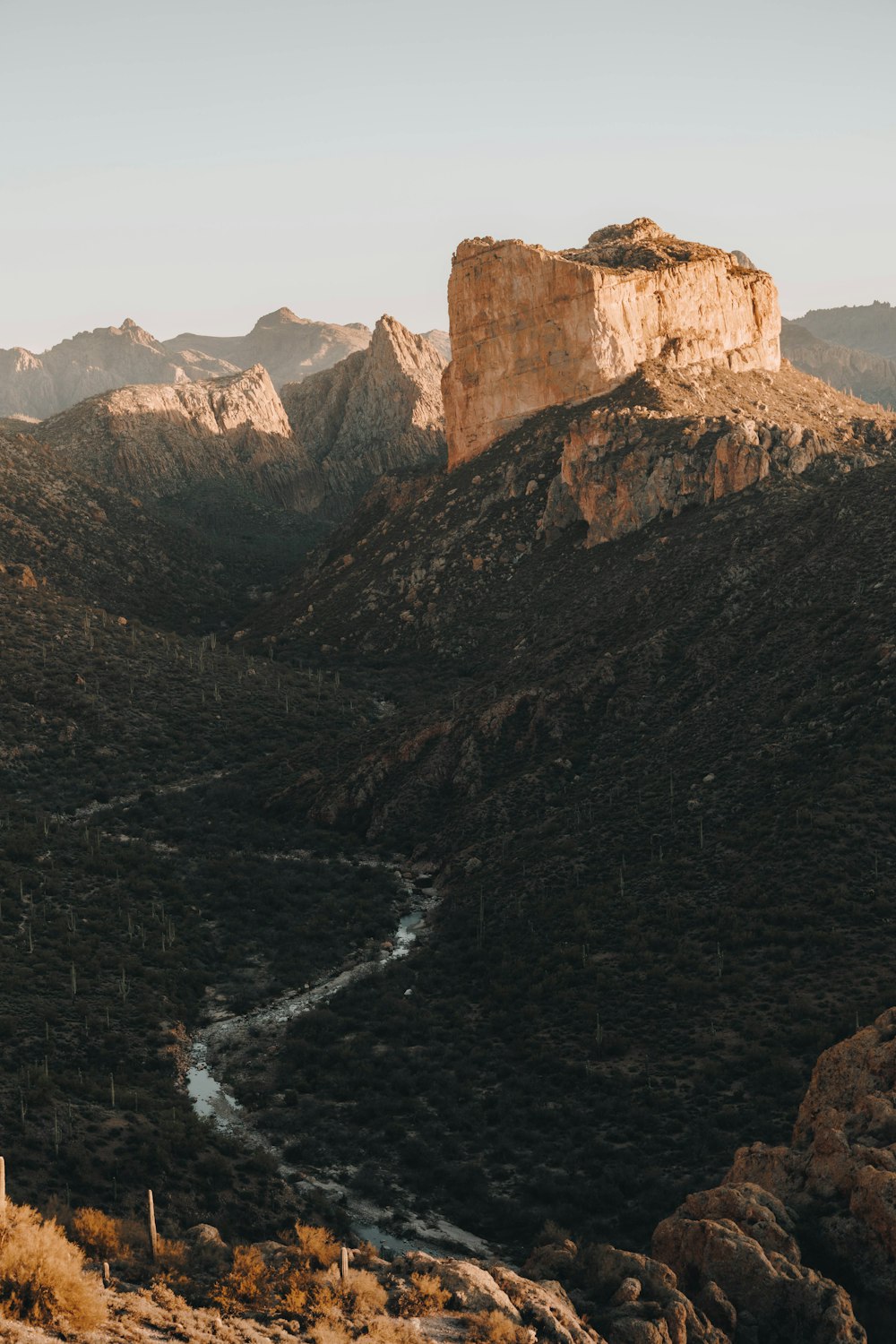 a river running through a valley surrounded by mountains