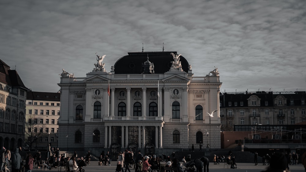 a group of people standing in front of a large building