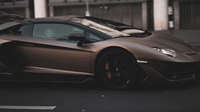 Dynamic shot of a sporty vehicle showcasing luxury rims with a glossy finish on a city street.