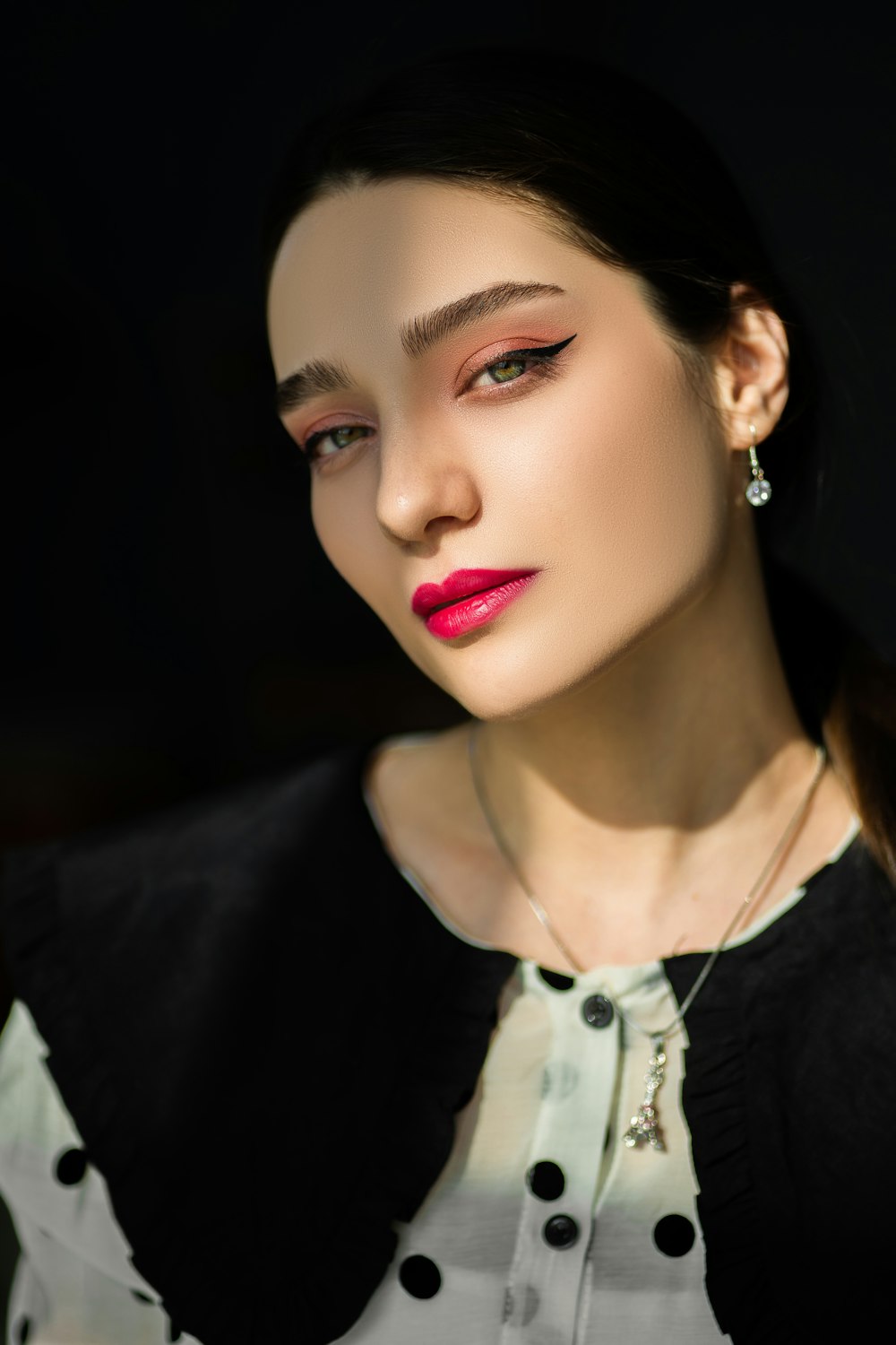 a woman with red lipstick and a black jacket