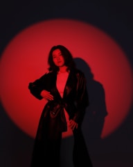 A confident entrepreneur standing under a spotlight with a black and gold theme.