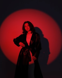 Close-up of 10dimes in a sleek jacket, spotlight highlighting his confident expression.