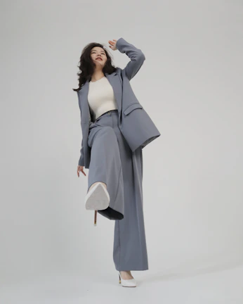 High-fashion model showcasing a tailored navy suit in a minimalist showroom