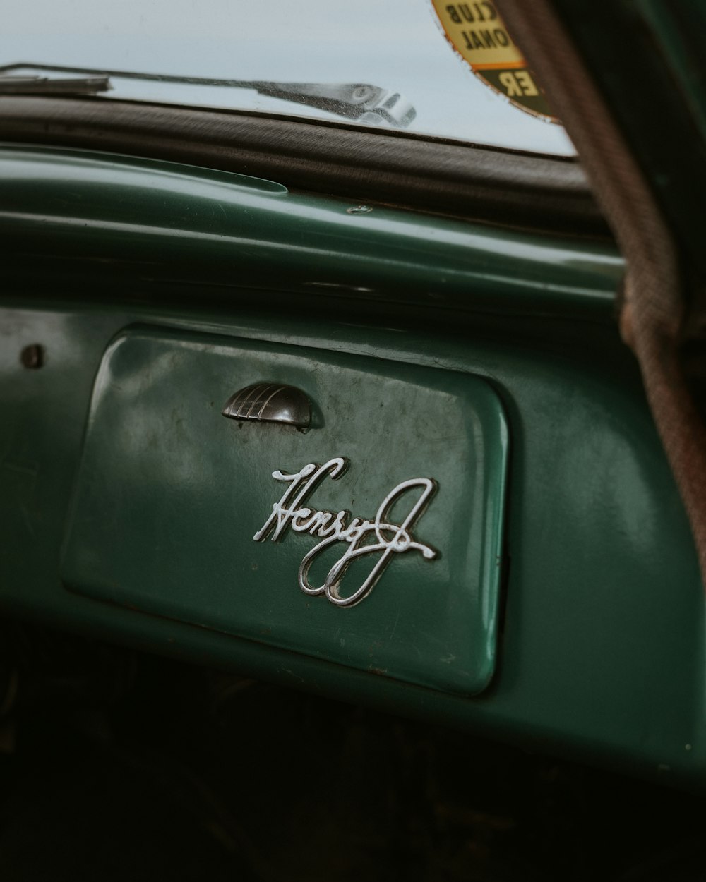 a close up of a car door with a sticker on it