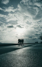 Men walking side by side along a stormy coastline, embodying perseverance.