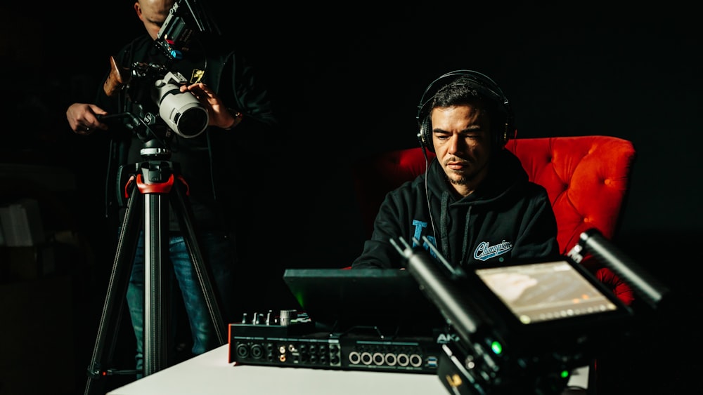 a man sitting in a chair with headphones on