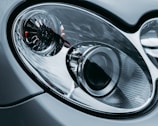 Close-up of a car headlight being repaired with precision tools.