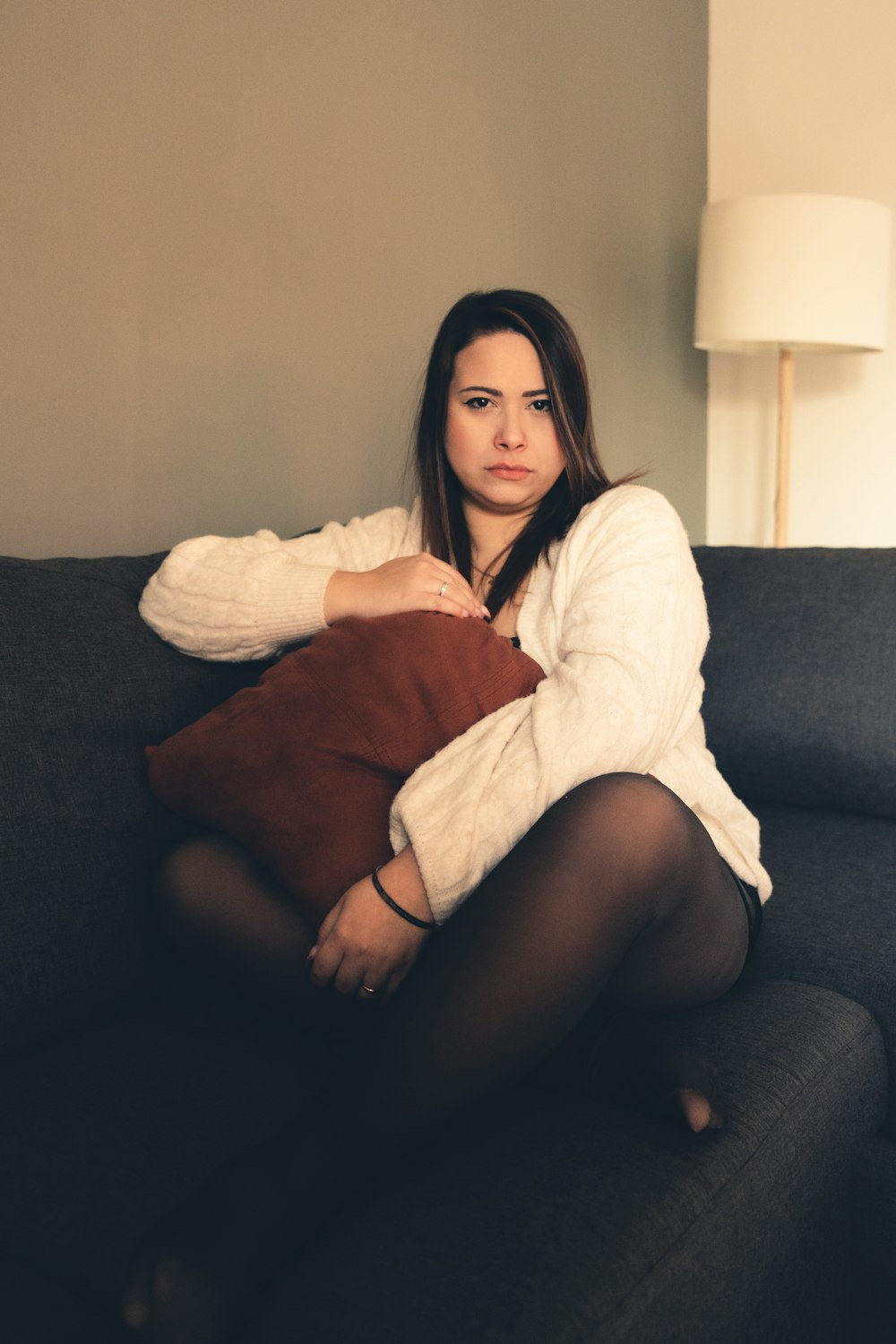 a woman sitting on top of a black couch