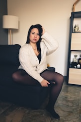 a woman sitting on a couch in a room