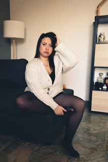 a woman sitting on a couch in a room