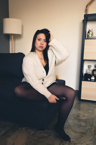 a woman sitting on a couch in a room