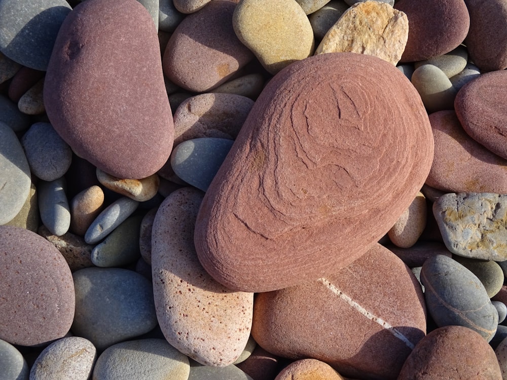 a close up of rocks and pebbles on a beach