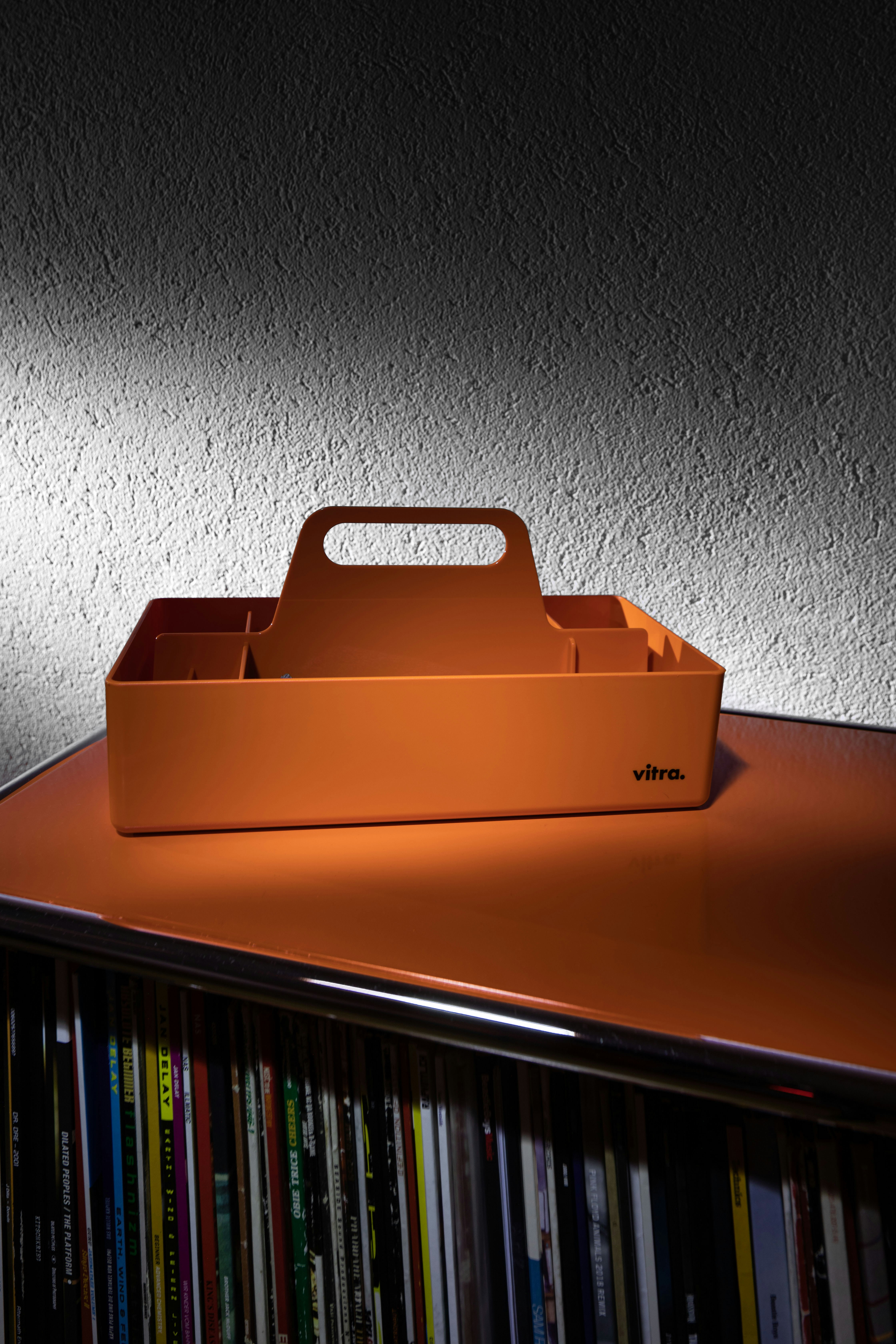 an orange box sitting on top of a shelf