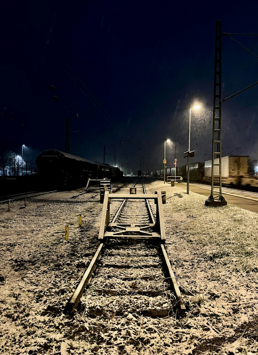 a train traveling past a train station at night