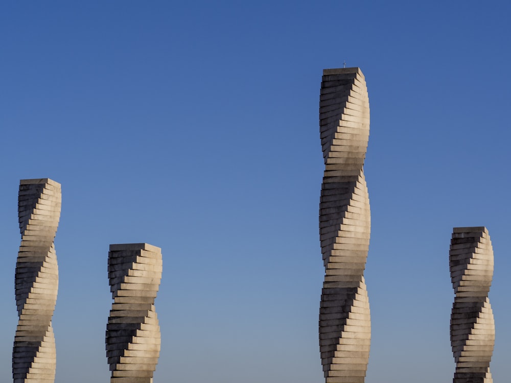 a group of tall sculptures sitting next to each other