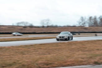 A dynamic shot of a race car drifting sharply on a wet track.