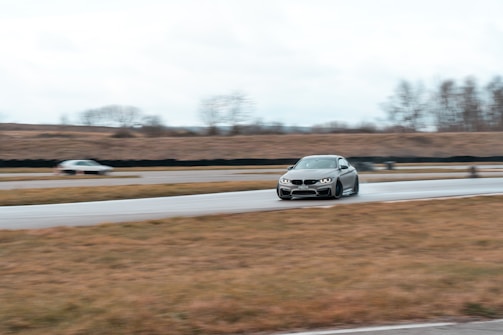 A dynamic shot of a race car drifting sharply on a wet track.