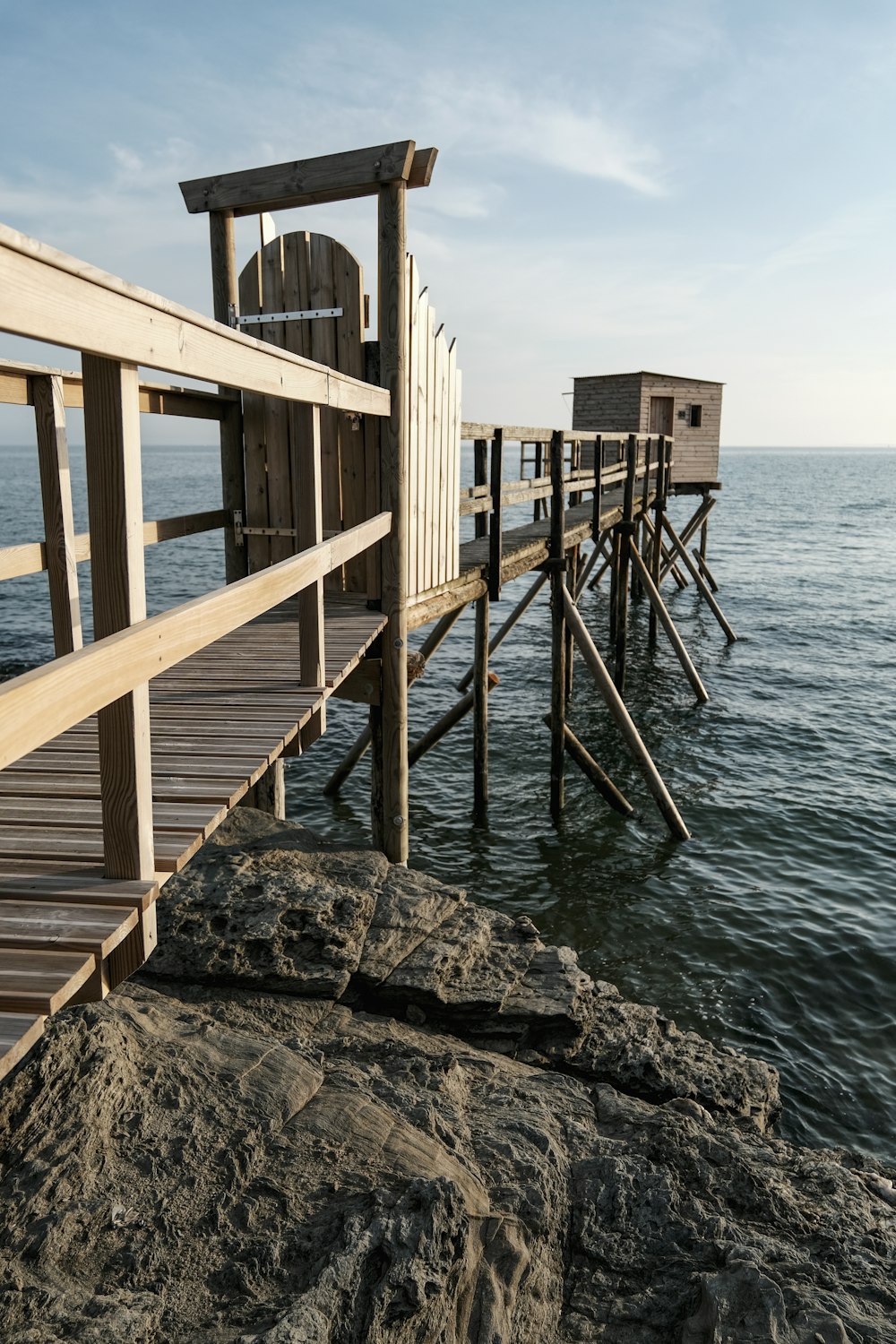 a wooden dock sitting on top of a large body of water