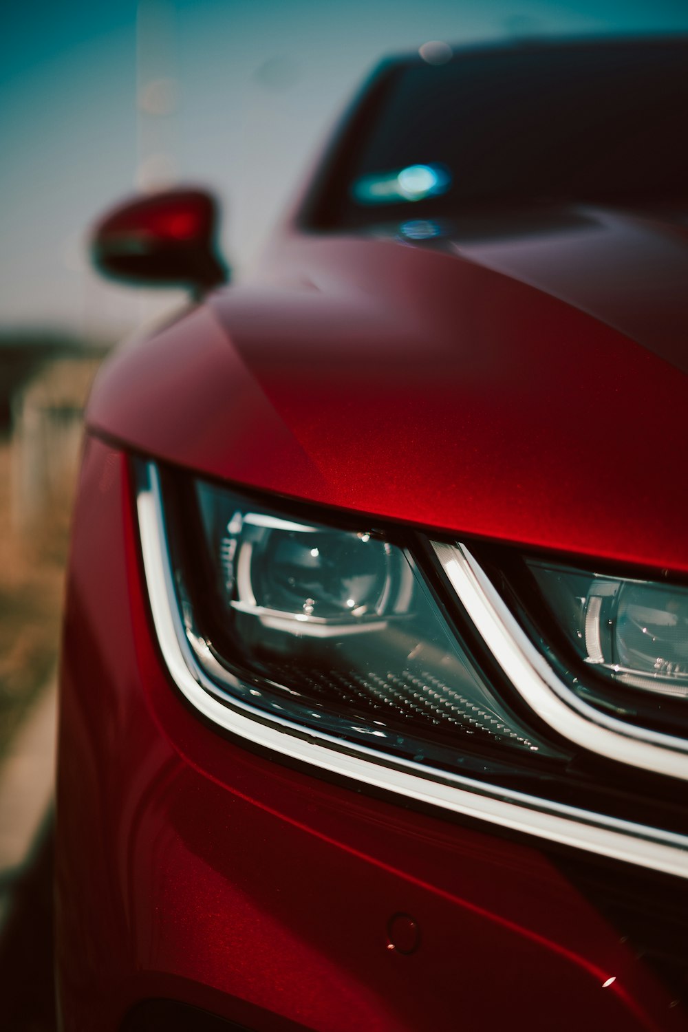 a close up of the front lights of a red car