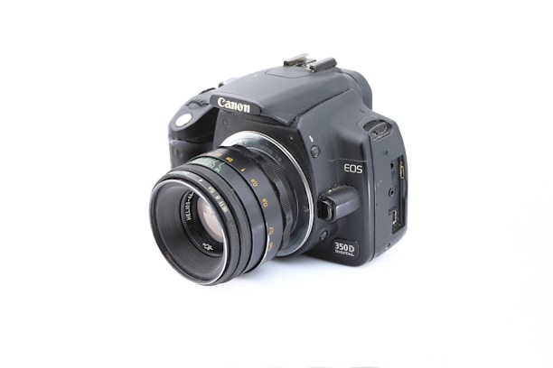 A sleek modern DSLR camera with lens attached, displayed against a clean white background.