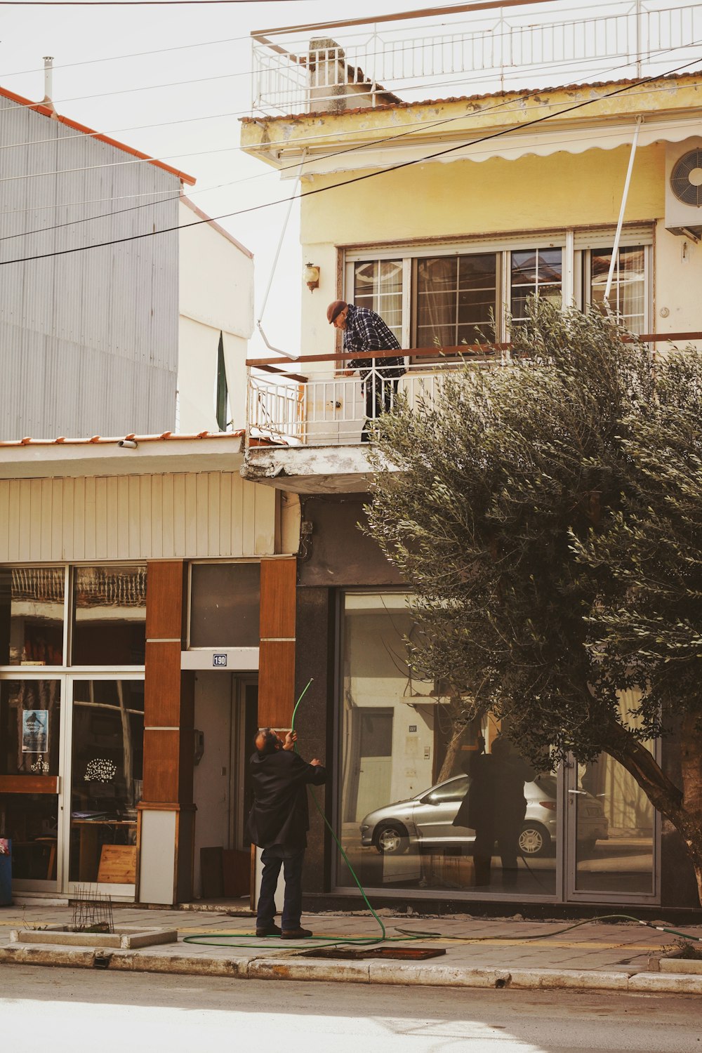 a man standing on a street corner in front of a building